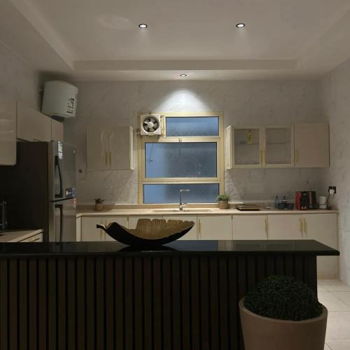 a kitchen with a bowl on a counter in a kitchen at Amal Hotel in Riyadh