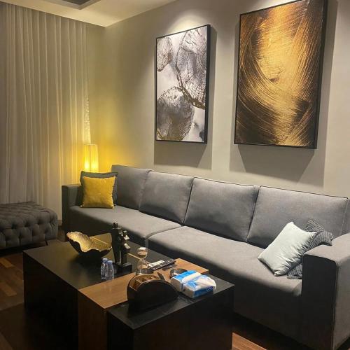 a living room with a couch and a coffee table at Amal Hotel in Riyadh