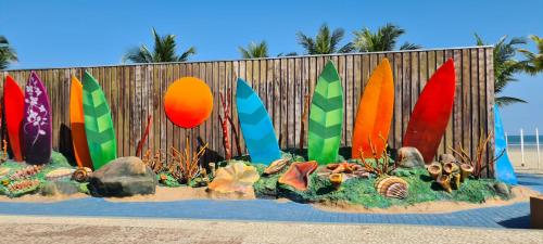 a display of surfboards in front of a fence at Encontro marcado in Praia Grande
