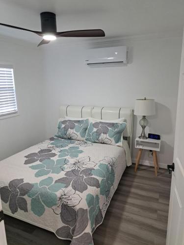 a bedroom with a bed and a ceiling fan at Country Blue Getaway by the Ranch Fields in Auburndale