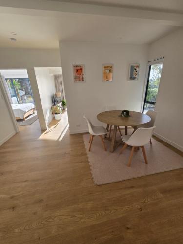 a living room with a wooden table and chairs at Apartment at the Beach in Red Beach