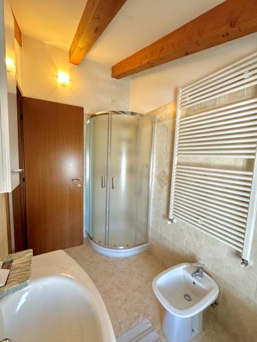 a bathroom with a shower and a tub and a sink at Open space centre in Lignano Sabbiadoro