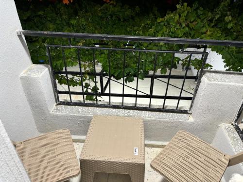two chairs and a table on a balcony at Akapella in Pamukkale