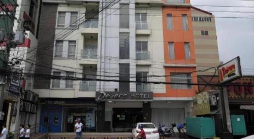 a building with a car parked in front of it at Devera Hotel in Angeles