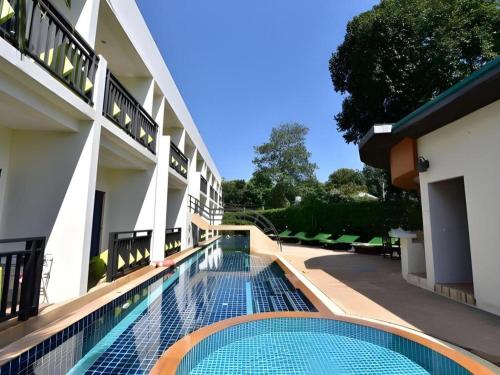 a swimming pool in the courtyard of a building at The Green Hotel in Ko Lipe