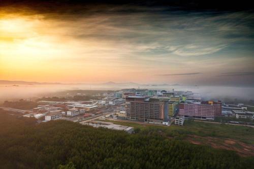 a city in the fog with buildings and trees at The Vista Hotel By Satit Group in Sadao