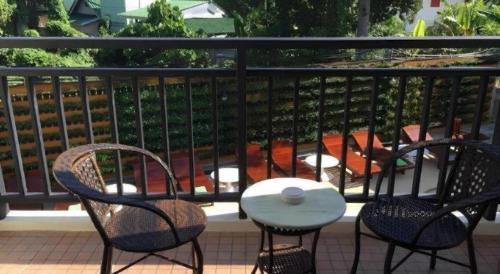 two chairs and a table on a balcony at The Green Hotel in Ko Lipe