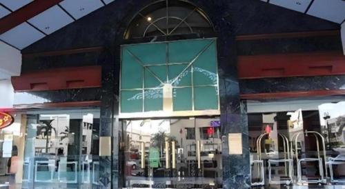 a building with a window with a cross on it at The CentrePoint Hotel in Bandar Seri Begawan