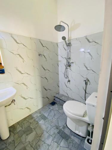 a bathroom with a toilet and a sink at Oracle Residence in Anuradhapura