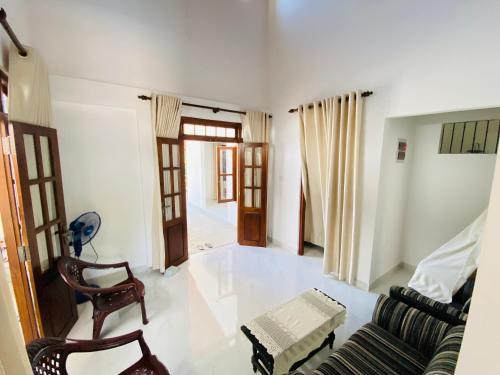 a living room with a couch and a chair at Oracle Residence in Anuradhapura