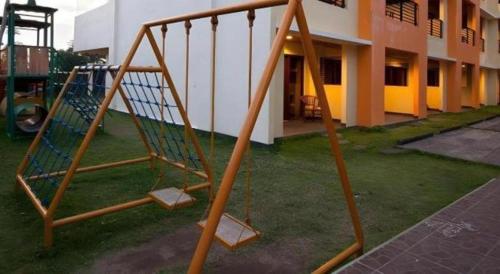 a wooden swing set in front of a building at Hotel Bintang Tawangmangu in Tawangmangu
