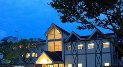 a building with its lights on in front of it at Hotel SP Haruno in Kochi
