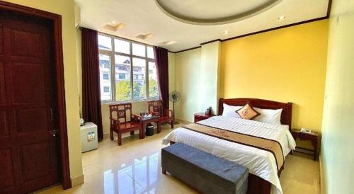 a bedroom with a bed and a large window at Gia Bao Hotel Bac Ninh in Hanoi