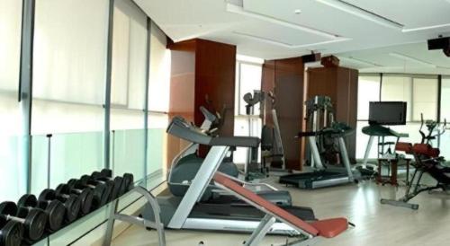 a gym with several exercise equipment in a room at Jinhua World Trade Hotel in Jinhua