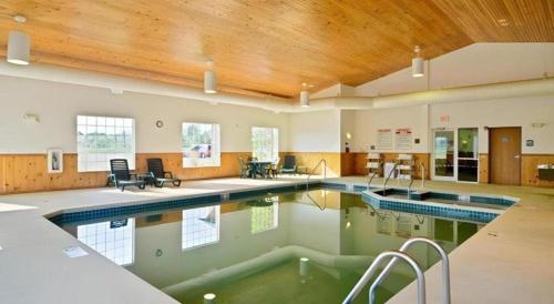 a large swimming pool in a building with a wooden ceiling at Jinhua World Trade Hotel in Jinhua