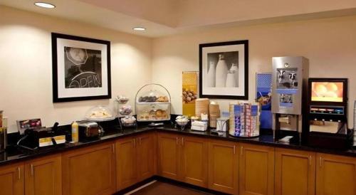 a room with a counter with food and a refrigerator at Flagstaff Hotel in Flagstaff