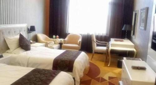 Ένα ή περισσότερα κρεβάτια σε δωμάτιο στο Metropark Hotel