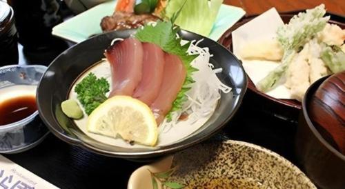 a bowl of food with meat and vegetables on a table at Hotel Matsuya in Shimanto