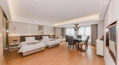 a hotel room with two beds and a dining room at Chengdu Antai Century Hotel in Chengdu