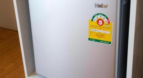 a refrigerator with a sign on the side of it at Baan Kula Mahasarakam in Maha Sarakham