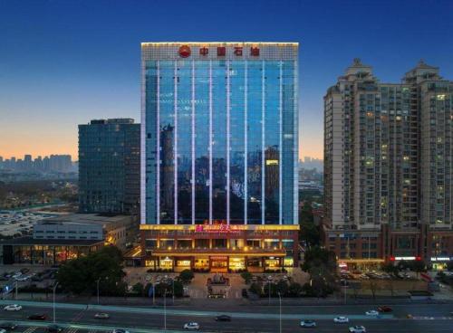 a large building with a lot of windows in a city at Wuhan Soluxe Hotel in Wuhan