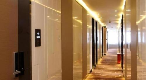a hallway of a building with a wooden floor and lights at Lavande Hotel Xian Xiaozhai Subway Station Dayanta Branch in Xi'an