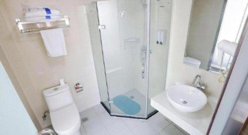 a bathroom with a shower and a toilet and a sink at 7 Days Inn Nanjing Gaochun Metro Station in Gaochun