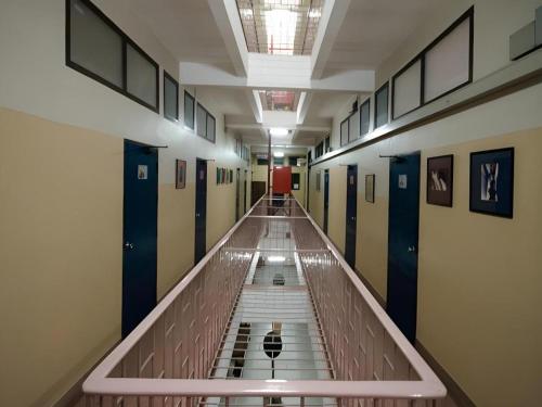 an empty hallway in a building with a long aisle at Numsin Hotel in Ratchaburi