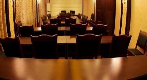 a conference room with rows of tables and chairs at Dunhuang Dunhe Hotel in Dunhuang