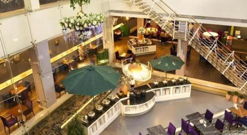 an overhead view of a restaurant with tables and umbrellas at Catic Hotel--Adjacent Buliding in Zhuhai