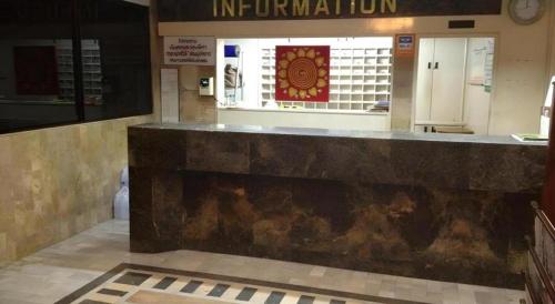 a lobby with a counter in a building at Numsin Hotel in Ratchaburi