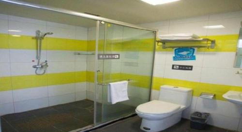 a bathroom with a shower and a toilet and a sink at 7 Days Inn Jinan Changqing Jingshi West Road Center in Jinan