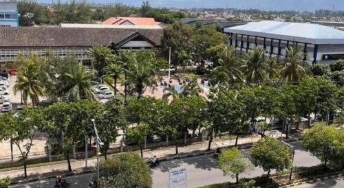 a building with a lot of trees in front of it at Hotel Mekkah Banda Aceh in Banda Aceh
