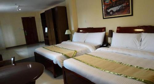 Ένα ή περισσότερα κρεβάτια σε δωμάτιο στο Time Travellers Hotel
