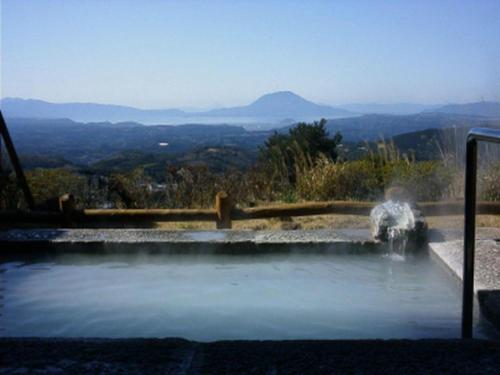 a hot spring with water spewing out of it at Kirishima Onsen Ryokojin Sanso in Kirishima