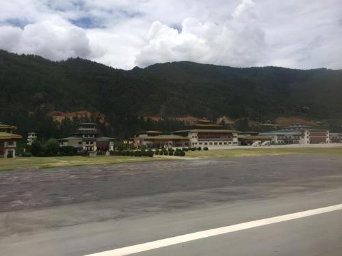 a group of buildings in front of a mountain at Hotel Valley Thimphu in Thimphu