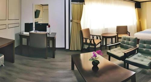 a hotel room with furniture and a living room at Horizon Hotel in Olongapo