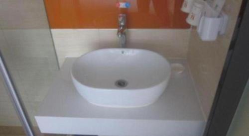 a bathroom with a white sink with a faucet at 7 Days Premium Beijing Dabaotai Metro Station Luhua Road in Beijing