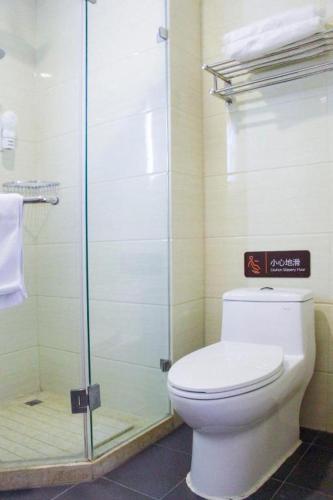 a bathroom with a toilet and a glass shower at 7 Days Premium Beijing Dabaotai Metro Station Luhua Road in Beijing
