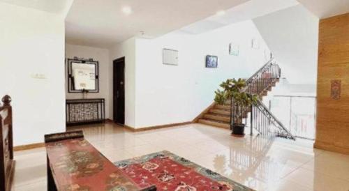 a living room with a staircase and a rug at Khang Residency Thimphu in Thimphu