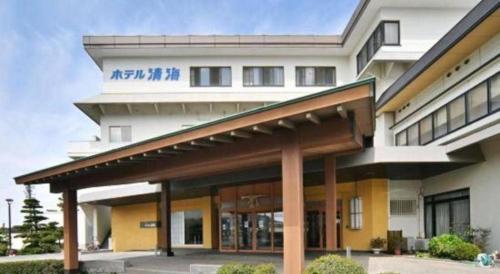 a large white building with a large entrance at Futami Onsen Hotel Seikai in Ise