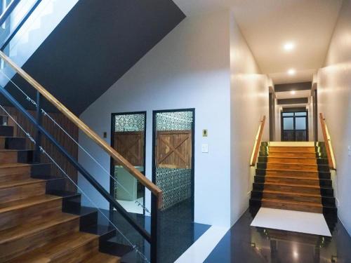 a staircase in a house with black and white walls at The Nest Hotel in Nakhon Ratchasima