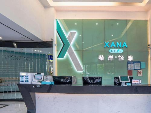 a store window with a karma clinic sign on it at Xana Lite Anqing Yuexi Swan Squre Branch in Yuexi