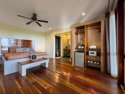 a bedroom with a bed and a ceiling fan at Nakabalo Guesthouse & Restaurant in Siquijor