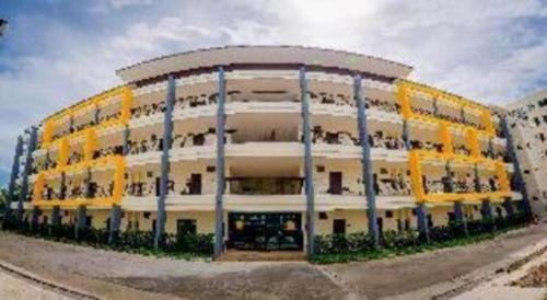 a large building with people on the balconies of it at The Nest Krabi Hotel in Ao Nang Beach