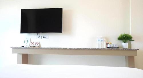 a flat screen tv hanging on a wall at The Nest Krabi Hotel in Ao Nang Beach