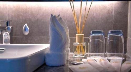 a bathroom counter with a sink and some bottles on it at danfeng kelly hotel in Shenzhen