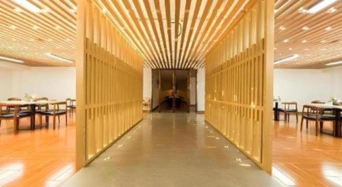 a hallway with tables and chairs in a room at Jinjiang Inn Select Xuzhou High-speed Railway Station Kunpeng Road in Xuzhou