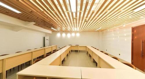 an empty lecture room with tables and chairs at Jinjiang Inn Select Xuzhou High-speed Railway Station Kunpeng Road in Xuzhou