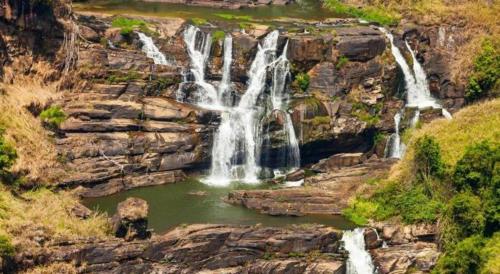a group of waterfalls on the side of a mountain at Talawakele Rest House in Nuwara Eliya